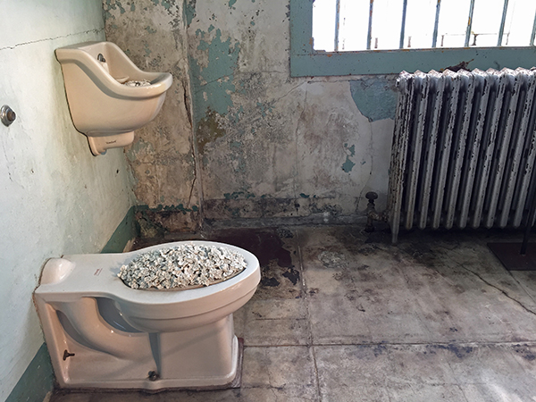 In the installation called Blossom, Ai Weiwei fills utilitarian fixtures—such as sinks, toilets and tubs—in several hospital ward cells with nature: delicate porcelain bouquets. ©Candice Gaukel Andrews