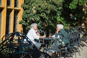 Two older women travelers talking over a glass of champagne