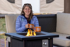 Nat Hab traveler having a hot cup of tea coffe hot chocolate by the fire cozy