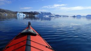 Sea kayak with icebergs in the distance