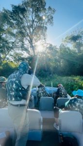 Guide and guests spotting a jaguar from the boat in the Pantanal, Brazil