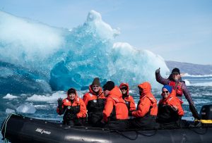 travelers on zodiac ride through glaciers in Greenland