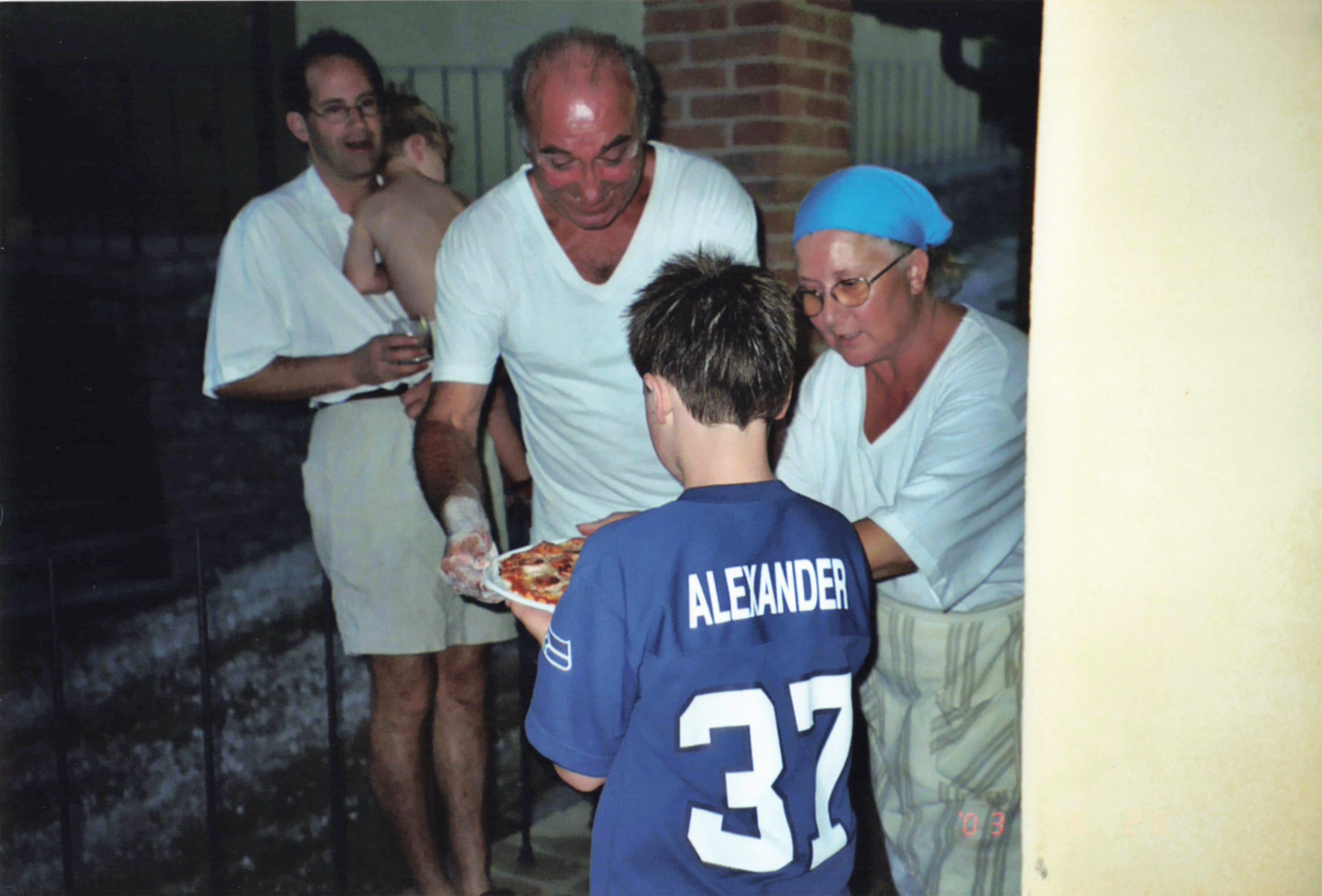 My brother being handed a pizza straight from the villa's outdoor wood-fired stone oven.