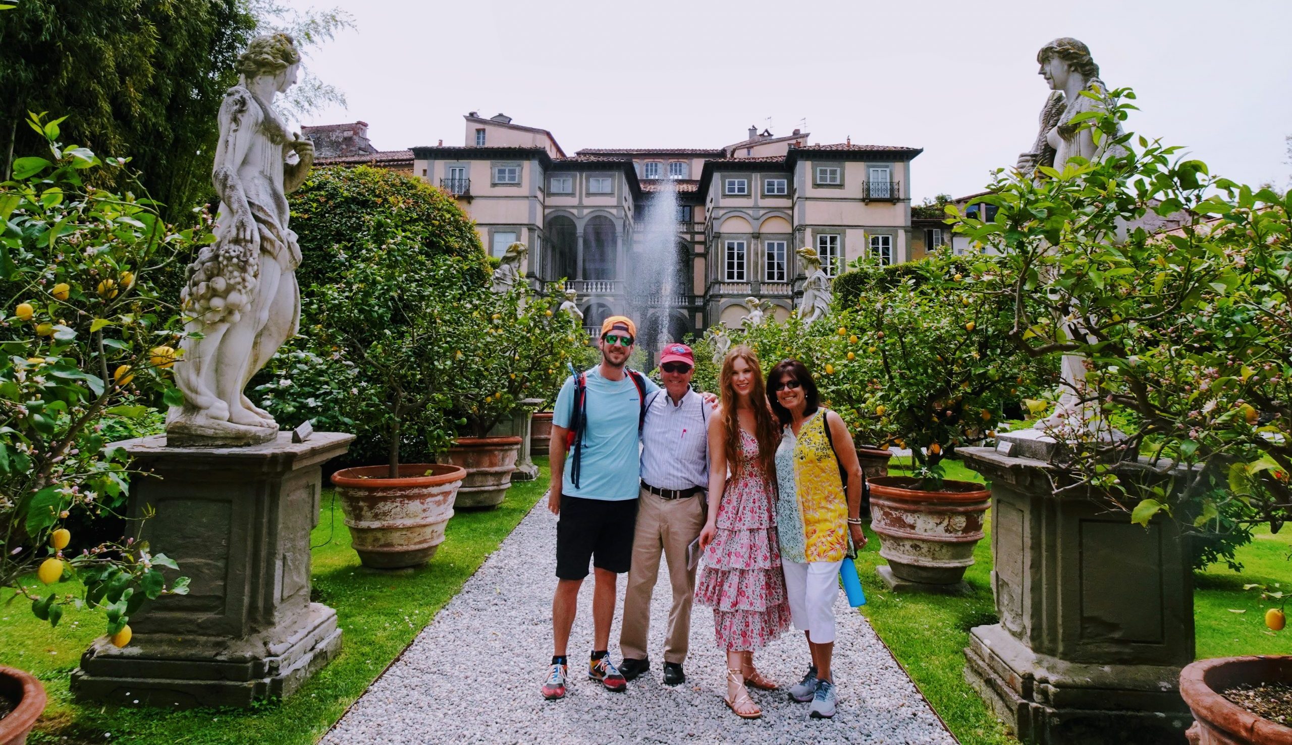 With my mother-in-law, father-in-law and brother-in-law at Palazzo Pfanner, an elegant Renaissance villa in Lucca dating to the 1660s. In its Baroque garden stands a statue of Amphitrite, goddess of the sea and bride of Poseidon, riding a shell-shaped chariot drawn by dolphins.